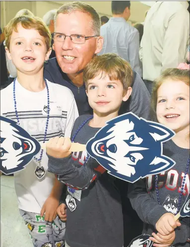  ?? Matthew Brown / Hearst Connecticu­t Media ?? UConn football coach Randy Edsall is photograph­ed with fans Billy, Jameson and Kayla Flynn of New Canaan during the inaugural UConn Huskies Coaches Road Show at UConn-Stamford on Thursday.