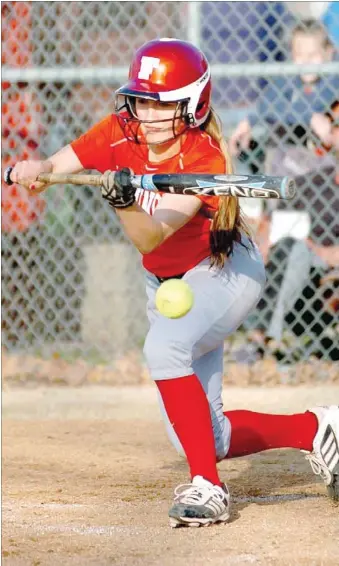  ?? RANDY MOLL NWA MEDIA ?? Farmington’s Oakley Sisemore bunts to get on base. The Lady Cardinals broke a scoreless tie in the fourth inning building momentum en route to an 11-0 conference win at Gentry on April 1.