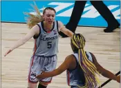  ?? ERIC GAY — THE ASSOCIATED PRESS ?? UConn guard Paige Bueckers, left, celebrates a basket with Aaliyah Edwards against Baylor at the Alamodome.