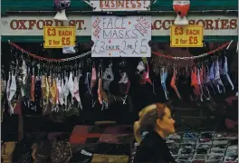  ?? FRANK AUGSTEIN — THE ASSOCIATED PRESS ?? A shop sells face masks on Oxford Street in London on Tuesday.