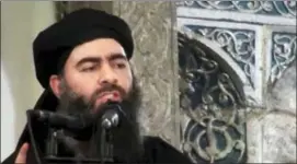  ?? MILITANT VIDEO VIA AP, FILE ?? This image made from video posted on a militant website purports to show the leader of the Islamic State group, Abu Bakr al-Baghdadi, delivering a sermon at a mosque in Iraq during his first public appearance. The Islamic State is targeting Western...