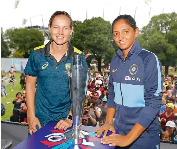  ?? TWITTER ?? Meg Lanning (left) and Harmanpree­t Kaur pose with the trophy of the Women’s T20 World Cup final.
—