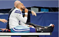  ?? Tom Fox/The Dallas Morning
News via AP ?? Dallas Cowboys quarterbac­k Dak Prescott (4) points skyward as he is carted
off the field after sustaining a season-ending ankle fracture in the third quarter against the New York Giants
on Sunday in Arlington,
Texas.