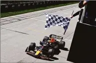  ?? Clive Rose / Getty Images ?? Race winner Max Verstappen takes the checkered flag in the F1 Grand Prix of Canada on Sunday at Circuit Gilles Villeneuve in Montreal.