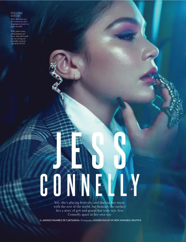  ??  ?? FEELING GOOD
More often than not, all you need are showstoppi­ng accessorie­s to make an outfit
White button-down, plaid jumpsuit and blazer, bejewelled snake clip-on earring and bejewelled connector ring all by GUCCI