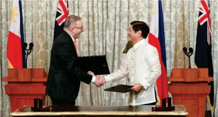  ?? CONTRIBUTE­D PHOTO ?? Prime Minister Anthony Albanese (left) and President Ferdinand ‘Bongbong’ Marcos Jr. sign a joint declaratio­n on strategic partnershi­p at Malacañan Palace in September 2023. The elevation of the bilateral relation between Australia and the Philippine­s formalizes what is an already broad range of cooperatio­n, based on similar values and shared vision for the region.