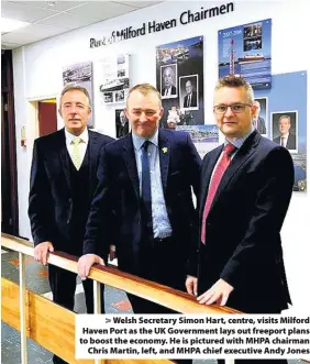  ??  ?? > Welsh Secretary Simon Hart, centre, visits Milford Haven Port as the UK Government lays out freeport plans to boost the economy. He is pictured with MHPA chairman Chris Martin, left, and MHPA chief executive Andy Jones