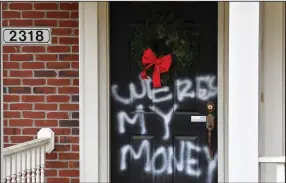  ?? (AP/Timothy D. Easley) ?? Graffiti reading “where’s my money” is painted on a door Saturday at the Louisville, Ky., home of Senate Majority Leader Mitch McConnell.
