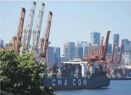  ?? DARRYL DYCK, THE CANADIAN PRESS ?? Gantry cranes are shown as a container ship is docked at port in Vancouver last summer. Canadian exports of thermal coal reached the highest level in almost a decade last year.