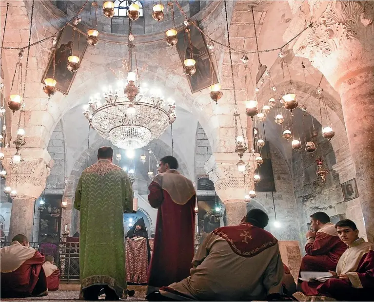  ??  ?? The clergy of the Armenian Apostolic Church celebrates mass in Saint Helena Chapel in the Holy Sepulchre, Jerusalem.