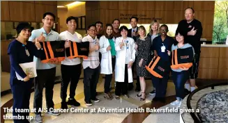  ??  ?? The team at AIS Cancer Center at Adventist Health Bakersfiel­d gives a thumbs up.