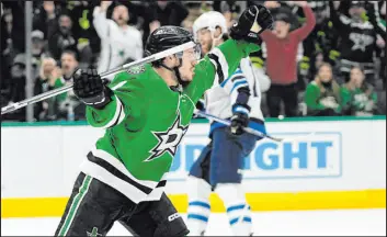  ?? Tony Gutierrez The Associated Press ?? Stars rookie Logan Stankoven celebrates after scoring a first-period goal Thursday during Central-leading Dallas’ 4-1 win over the Jets at American Airlines Center.