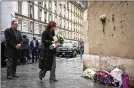  ?? NEW YORK TIMES ?? U.S. Vice President Kamala Harris and her husband lay flowers at a memorial to Paris terror victims.