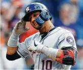  ?? David Zalubowski / Associated Press ?? Yuli Gurriel salutes on-deck hitter Josh Reddick after homering in the second inning.