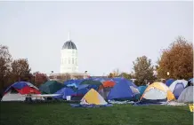  ??  ?? COLUMBIA: Tents remain on the Mel Carnahan quad on the campus of University of Missouri - Columbia in Columbia, Missouri. University of Missouri System President Tim Wolfe resigned yesterday amid protests over racial tensions at the university. — AFP