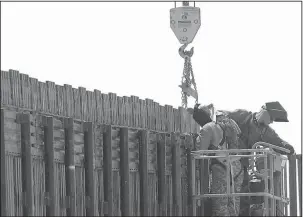  ?? The Associated Press ?? BORDER FENCE: In this June 13, 2006, file photo, Utah National Guard soldiers work on extending a border fence in San Luis, Ariz., President Donald Trump said April 3, he wants to use the military to secure the U.S.-Mexico border until his promised...