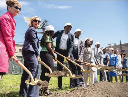  ?? PAT NABONG/SUN-TIMES ?? ABOVE: City and county officials join West Woodlawn Pointe developers to break ground during the launch of the Buy Back the Block initiative at 6314 S. Evans Ave. on Tuesday. BELOW: A rendering of a West Woodlawn Pointe three-flat.