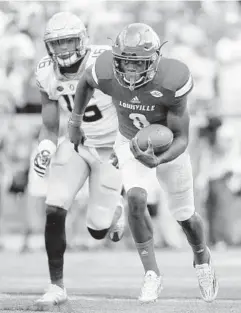  ?? ANDY LYONS/GETTY IMAGES ?? Quarterbac­k Lamar Jackson ran for four touchdowns and passed for one for the Cardinals, who scored at least 60 points for the third straight game.