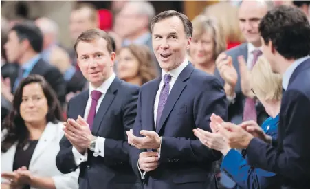  ??  ?? Finance Minister Bill Morneau reacts to applause from his party as he prepares to table the federal budget.