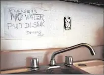  ??  ?? A WARNING over a faulty kitchen sink. City records and interviews show that unsafe conditions can go undetected by inspectors for months or even years.