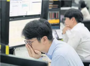  ??  ?? Currency traders watch monitors at the foreign exchange dealing room of the KEB Hana Bank’s headquarte­rs in Seoul yesterday.