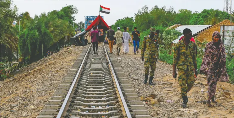  ?? ASHRAF SHAZLY / GETTY IMAGE ?? The Sudanese Railway Corp. has some of the most extensive rail networks in Africa, but the system, which represents a lifeline for the country, has fallen into decrepitud­e after
years of government corruption during the dictatorsh­ip of Omar al-bashir. There is a Us$640-million plan to resurrect the railroad network.