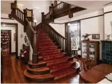  ??  ?? The foyer in the historic home of Mikey and Allen Isbell shows the home’s dramatic staircase that splits to each side.