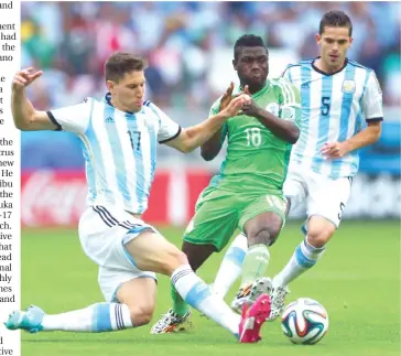  ??  ?? Super Eagles' Babatunde Michael is tackled by two Argentine players during their Group F clash at the 2014 FIFA World Cup in Brazil.
