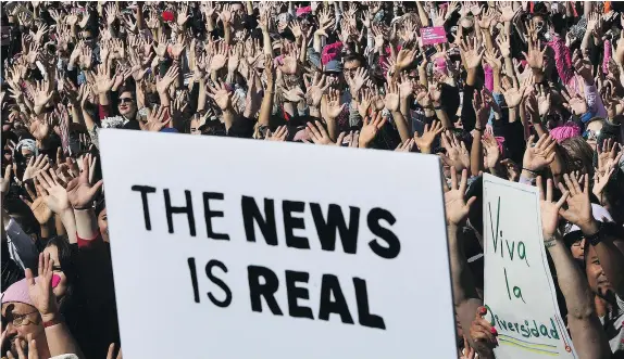  ?? — PHOTOS: GETTY IMAGES ?? Protesters, part of a 500,000 strong crowd, take part in Saturday’s rally in Los Angeles. Protesters took to the streets across the U.S. hoisting anti-Donald Trump placards and donning pink hats one year to the day of Trump’s inaugurati­on.