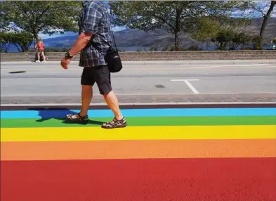  ?? The Daily Courier ?? Town crews have painted a Rainbow Sidewalk on Beach Avenue in Peachland. The project was approved by council during 2020 budget discussion­s as a show of support for marginaliz­ed communitie­s.