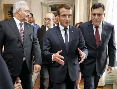  ?? AFP ?? French president Emmanuel Macron, centre, his foreign minister Jean-Yves Le Drian, second left, Libyan prime minister Fayez Al Sarraj, right, and Field Marshal Khalifa Haftar head to the talks yesterday that resulted in a truce for Libya