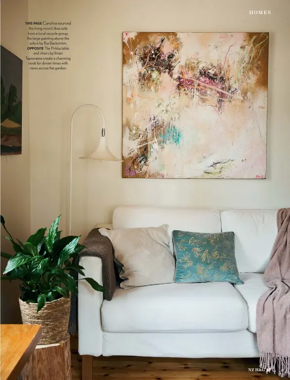  ??  ?? THIS PAGE Carolina sourced the living room’s Ikea sofa from a local recycle group; the large painting above the sofa is by Ria Bäckström. OPPOSITE The Pirkka table and chairs by Ilmari Tapiovaara create a charming nook for dinner times with views across the garden.