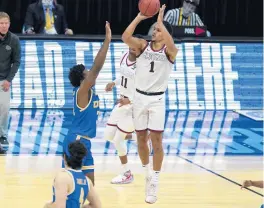  ?? AP PHOTO/MICHAEL CONROY ?? Gonzaga guard Jalen Suggs (1) shoots over UCLA guard David Singleton (34) for the gamewinnin­g basket in Saturday’s semifinal.