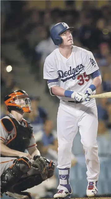  ?? Allen J. Schaben Los Angeles Times ?? CODY BELLINGER WATCHES the ball soar into the right-field pavilion for a three-run homer in the third inning, giving the Dodgers a 4-1 lead and Bellinger the National League record for home runs by a rookie, 39.