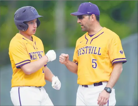  ?? Matthew Brown / Hearst Connecticu­t Media ?? Westhill’s Leo Socci fist pumps first base coach Chris Antonacci after hitting a single against Darien in the second inning of a 4-3 victory on May 11 in Stamford.