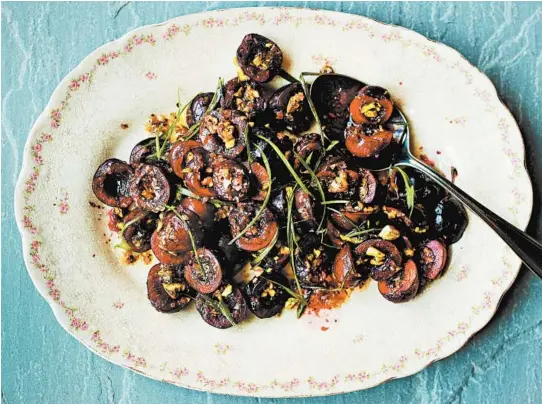  ?? JOHNNY MILLER/THE NEW YORK TIMES ?? Black cherry salad turns cherries into something savory, alongside charred scallions and creamy raw pistachios.