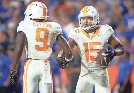  ?? BRIANNA PACIORKA/KNOXVILLE NEWS SENTINEL ?? Tennessee receiver Bru Mccoy, right, is congratula­ted by receiver Ramel Keyton after scoring against Florida on Sept. 16. A new NCAA proposal would allow for unlimited transfers without penalty.