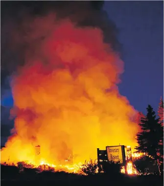  ?? ANDREW BROOKS, THE VICTORIA STANDARD VIA CP ?? A fire burns at the Inverary Resort in Baddeck, N.S. The main lodge of a historic inn on Cape Breton’s Bras d’Or Lakes was destroyed by a raging fire early Thursday, taking with it one of the community's main employers and a popular site dating back to...