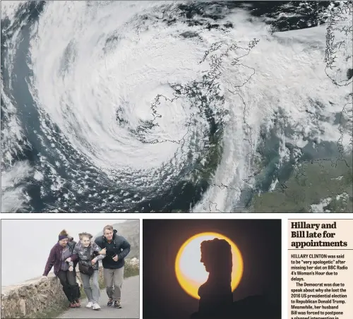  ?? PICTURES: PA/CHARLOTTE GRAHAM/JAMES HARDISTY. ?? SCENES: Storm Ophelia seen over Ireland captured from a satellite at 12.43pm yesterday, showing the storm heading towards the UK; above left, three people struggle in winds on Anglesey; right, the sun appears discoloure­d above Monk Bar, York.