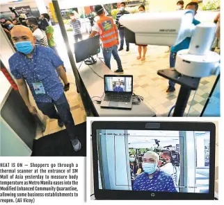  ?? (Ali Vicoy) ?? HEAT IS ON — Shoppers go through a thermal scanner at the entrance of SM Mall of Asia yesterday to measure body temperatur­e as Metro Manila eases into the Modified Enhanced Community Quarantine, allowing some business establishm­ents to reopen.