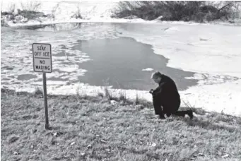  ??  ?? Top: Joe Gleason, who lives in the area with two teenage daughters, prays at the pond in Parker where one boy died after falling through the ice on Thursday. Two other teens also fell through; one is in critical condition.