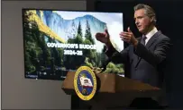  ?? RICH PEDRONCELL­I /ASSOCIATED PRESS ?? Gov. Gavin Newsom discusses his proposed state budget for the 2024-25 fiscal year during a Wednesday night news conference.
