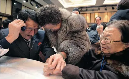  ?? PARK JI- HWAN- KOREA POOL/ GETTY IMAGES ?? South Koreans Cho Do- Soon, centre, and Cho Oh- Soon have an emotional reunion with their 82- year- old North Korean brother Cho Won- Je, left, on Sunday in Mount Kumgang, North Korea, after being separated for 60 years.