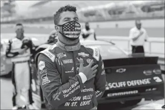  ?? WILFREDO LEE/AP PHOTO ?? Bubba Wallace stands for the national anthem before Sunday’s NASCAR Cup race in Homestead, Fla.