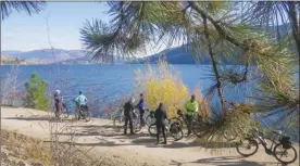  ?? Special to The Okanagan Weekend ?? On a sunny weekend day, the Okanagan Rail Trail can still be a busy place. Last Sunday, though, a headwind from the north resulted in whitecaps on Kalamalka Lake but the wind died by early afternoon making it a pleasant outing.