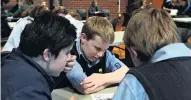  ?? PHOTOS: LINDA ROBERTSON ?? Lost in thought . . . Taieri College pupils (from left) Fletcher Beulink (13), Jakob Joyce (13) and William Helm (13) work at identifyin­g photograph­s.