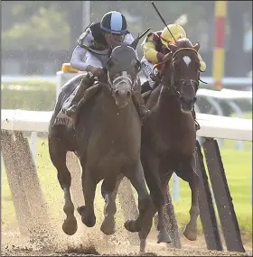  ?? AP/MARY ALAFFER ?? Tapwrit (left), ridden by Jose Ortiz, edges past Irish War Cry and jockey Rajiv Maragh to win the Belmont Stakes by 2 lengths on Saturday in Elmont, N.Y. Tapwrit’s winning time was 2:30.02.