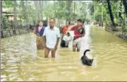  ?? PTI ?? Villagers move to a safer place from a flood-affected area after heavy rain, in Assam’s Nalbari district on Sunday.