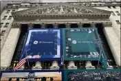  ?? PETER MORGAN — THE ASSOCIATED PRESS ?? General Electric banners hang on the facade of New York Stock Exchange on Tuesday. GE completed its split of the one-time conglomera­te into three separate companies.