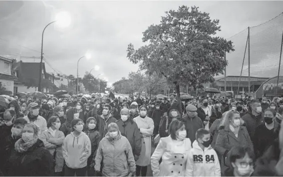  ?? DMITRY KOSTYUKOV/THE NEW YORK TIMES 2020 ?? A march is held in October in honor of teacher Samuel Paty in Conflans-Sainte-Honorine, France. Paty, 47, was beheaded Oct. 16 in suburban Paris by an 18-year-old man of Chechen origin who was angered by the teacher showing caricature­s of the Prophet Muhammad in a class. The 18-year-old was later killed by police.